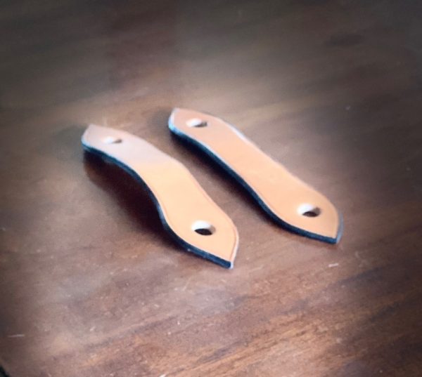 Photo of two leather slobber straps